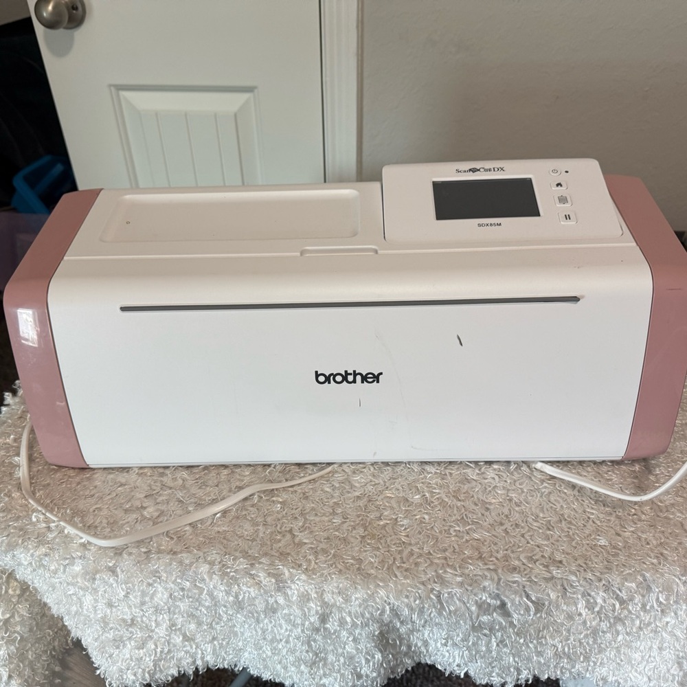 Brother White and Pink Electronic Device
